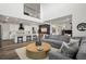 Open-concept living area with a stylish gray sectional, kitchen with breakfast bar, and modern decor at 17121 Desert Wine Ln, Parker, CO 80134