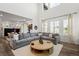 Bright and airy living room features soaring ceilings, large windows, and a comfortable gray sectional at 17121 Desert Wine Ln, Parker, CO 80134