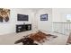 Cozy loft area with a decorative cowhide rug, modern entertainment center, and natural light at 17121 Desert Wine Ln, Parker, CO 80134