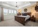 Stunning main bedroom with wood accent wall, tray ceiling, and rustic furniture at 17121 Desert Wine Ln, Parker, CO 80134