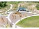 Aerial view of a community playground with various play structures, pathways, and green spaces for Gathering fun at 17121 Desert Wine Ln, Parker, CO 80134