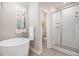 Bathroom featuring a soaking tub and glass-enclosed shower at 375 Josephine St # D, Denver, CO 80206