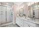 Bathroom featuring a glass shower and double sink vanity with ample cabinet space at 375 Josephine St # D, Denver, CO 80206