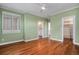 Bedroom with hardwood floors and doors leading to bathroom and closet space at 375 Josephine St # D, Denver, CO 80206