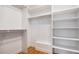 Walk-in closet with custom shelving and a bench for organized storage at 375 Josephine St # D, Denver, CO 80206