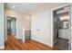 Bright hallway featuring hardwood floors, closet, and access to a modern bathroom at 375 Josephine St # D, Denver, CO 80206