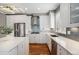 Bright kitchen featuring stainless steel appliances, quartz countertops, and sleek white cabinetry at 375 Josephine St # D, Denver, CO 80206