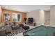 Staged basement living room includes television and pool table at 375 Josephine St # D, Denver, CO 80206