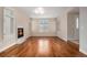 Bright living room featuring hardwood floors, fireplace, plantation shutters, and modern lighting at 375 Josephine St # D, Denver, CO 80206