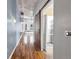 Long hallway with wood floors and barn door leading to laundry at 1700 Bassett St # 502, Denver, CO 80202