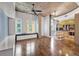 This living room features a large window seat, hard wood floors, a ceiling fan, and concrete ceilings at 1700 Bassett St # 502, Denver, CO 80202