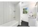 Modern bathroom features a tiled shower/tub combo and stylish vanity with granite countertop at 13483 Alcott Way, Broomfield, CO 80020