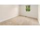 Empty bedroom showcasing neutral carpet, white shiplap wall, and natural light at 13483 Alcott Way, Broomfield, CO 80020