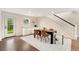 Bright dining area with a modern table set, white rug, and staircase access at 13483 Alcott Way, Broomfield, CO 80020