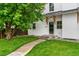 Charming two-story home with a lush lawn, a walkway to the front door, and a beautiful shade tree at 13483 Alcott Way, Broomfield, CO 80020
