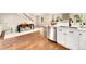 Open kitchen and dining area featuring hardwood floors, white cabinets, and stainless steel appliances at 13483 Alcott Way, Broomfield, CO 80020