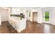 Modern kitchen featuring white cabinets, wooden floors, a stylish breakfast bar, and ample counter space at 13483 Alcott Way, Broomfield, CO 80020