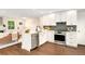 Contemporary kitchen featuring stainless steel appliances, white cabinets, wooden floors, and plenty of natural light at 13483 Alcott Way, Broomfield, CO 80020