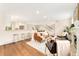 Open-concept living room featuring a fireplace, hardwood floors, and seamlessly connected spaces for modern living at 13483 Alcott Way, Broomfield, CO 80020