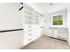 Spacious walk-in closet features custom shelving, drawers, and hanging rods for organized storage at 13483 Alcott Way, Broomfield, CO 80020