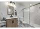 Modern bathroom featuring a tiled shower, patterned tile floor and updated vanity at 5557 Aspen Ave, Erie, CO 80516