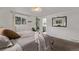 Bedroom featuring a large bed, stylish mirror, and a glimpse of the en suite bathroom at 5557 Aspen Ave, Erie, CO 80516