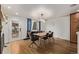 Bright dining room with modern table and chairs, hardwood floors, and stylish lighting at 5557 Aspen Ave, Erie, CO 80516