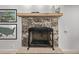 Close-up of the stone fireplace with a wooden mantel and hearth, adding warmth and character at 5557 Aspen Ave, Erie, CO 80516