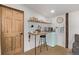 Convenient kitchenette with open shelving and a stylish retro mini fridge at 5557 Aspen Ave, Erie, CO 80516