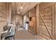 Wood paneled living space featuring a sliding door, kitchenette and piano at 5557 Aspen Ave, Erie, CO 80516