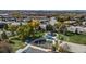 Aerial view of community playground, colorful fall foliage, and ample parking at 10779 Longs Way, Parker, CO 80138