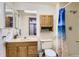 Simple bathroom features a vanity sink with drawers, framed mirror, and a shower tub combination at 10779 Longs Way, Parker, CO 80138