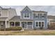 Charming blue two-story home with a covered front porch, manicured lawn, and white trim at 10779 Longs Way, Parker, CO 80138