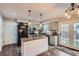 Well-lit kitchen featuring a center island, stainless steel appliances, and a door to the backyard at 10779 Longs Way, Parker, CO 80138