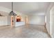 Open concept living room with tile floors and kitchen access at 3082 S Wheeling Way # 408, Aurora, CO 80014