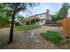 Spacious backyard featuring a trampoline, deck, and mature trees at 11538 E Highline Pl, Aurora, CO 80010