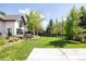 Spacious backyard with lush lawn, patio area, and mature trees at 3445 S Clermont St, Denver, CO 80222