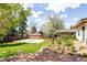 A large backyard with a basketball court, patio and garden at 3445 S Clermont St, Denver, CO 80222