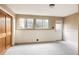 Spacious bedroom with natural light, neutral carpet, large wardrobe, and simple wall decor at 3445 S Clermont St, Denver, CO 80222