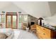 Bright bedroom has vaulted ceilings, wood doors to balcony, and modern decor at 3445 S Clermont St, Denver, CO 80222