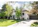 Charming stucco home with mature trees, large driveway, and attached two-car garage at 3445 S Clermont St, Denver, CO 80222