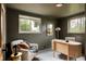 Stylish home office featuring a modern desk, comfortable armchair, and natural light from the windows at 3445 S Clermont St, Denver, CO 80222