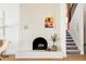 Elegant fireplace with unique textured design, complemented by stylish decor and a cozy staircase, offering a sophisticated interior touch at 3445 S Clermont St, Denver, CO 80222