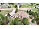 An aerial shot showcasing a house with a concrete driveway and a well-maintained yard surrounded by lush trees at 1120 Brenthaven Ct, Monument, CO 80132