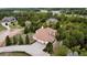 An aerial view of a house in a wooded area with other homes nearby, showing the driveway and surroundings at 1120 Brenthaven Ct, Monument, CO 80132