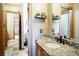 Bathroom showcasing a stylish granite countertop vanity and doorway to the adjacent room at 1120 Brenthaven Ct, Monument, CO 80132