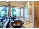 Elegant bathroom with dual vessel sinks, a soaking tub, and a large window overlooking a wooded area at 1120 Brenthaven Ct, Monument, CO 80132