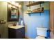 Stylish bathroom featuring a modern vanity, decorative shelves, and tiled floors that contribute to a functional layout at 1120 Brenthaven Ct, Monument, CO 80132