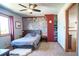 Cozy bedroom with a unique accent wall, plush carpeting, and a ceiling fan for added comfort at 1120 Brenthaven Ct, Monument, CO 80132