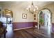 An inviting dining room with hardwood floors, a chandelier, and arched doorways, blending style and functionality at 1120 Brenthaven Ct, Monument, CO 80132